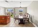 Dining area with tile flooring, a dark wood table and a view to the backyard at 358 Canna Dr, Davenport, FL 33897