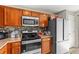 Functional kitchen features stainless steel oven, microwave, refrigerator and generous cabinet storage space at 358 Canna Dr, Davenport, FL 33897