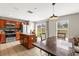 Bright kitchen features stainless appliances, wood cabinets, kitchen island, and a view of the backyard at 358 Canna Dr, Davenport, FL 33897