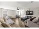 Bright living room with hardwood floors, sofas, and a ceiling fan for air circulation at 358 Canna Dr, Davenport, FL 33897