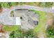 Overhead aerial view of the large, landscaped yard featuring the home, driveway, and large surrounding mature trees at 3979 Mammoth Grove Rd, Lake Wales, FL 33898
