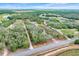 Aerial view featuring the property with boundary lines, beautiful landscaping, a house, and surrounding greenery at 3979 Mammoth Grove Rd, Lake Wales, FL 33898