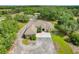 Aerial view of a beautiful home with mature landscaping, circular driveway, and guest house at 3979 Mammoth Grove Rd, Lake Wales, FL 33898