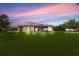 Spacious backyard features a screened patio with seating, lush green grass and mature trees offering shade and privacy at 3979 Mammoth Grove Rd, Lake Wales, FL 33898