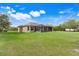 Expansive backyard featuring a well-maintained lawn, a screened-in porch, and attractive landscaping at 3979 Mammoth Grove Rd, Lake Wales, FL 33898