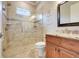 Modern bathroom featuring a glass shower, a wooden vanity with granite countertop, and decorative wall art at 3979 Mammoth Grove Rd, Lake Wales, FL 33898