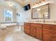 Bathroom with a large tub, vanity with granite countertop, and a large mirror at 3979 Mammoth Grove Rd, Lake Wales, FL 33898