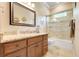 Bright bathroom featuring a granite countertop vanity and a glass-enclosed shower at 3979 Mammoth Grove Rd, Lake Wales, FL 33898