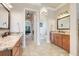 Elegant bathroom featuring dual vanities with granite countertops and stylish fixtures, leading to the main bedroom at 3979 Mammoth Grove Rd, Lake Wales, FL 33898