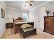 Traditional bedroom with a decorative ceiling fan, dark wooden furniture, and a comfortable bed at 3979 Mammoth Grove Rd, Lake Wales, FL 33898