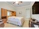 Cozy bedroom featuring neutral walls, ceiling fan, and built-in wooden cabinets and drawers surrounding the bed at 3979 Mammoth Grove Rd, Lake Wales, FL 33898