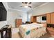 Bedroom with custom oak headboard, TV, armoire, and plushy chair at 3979 Mammoth Grove Rd, Lake Wales, FL 33898