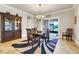 Dining room with wooden table, chairs and a patterned rug, adjacent to sliding glass doors at 3979 Mammoth Grove Rd, Lake Wales, FL 33898