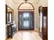 Inviting entryway with tiled flooring, a decorative front door, and ample natural light at 3979 Mammoth Grove Rd, Lake Wales, FL 33898