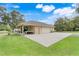 Detached garage featuring a side portico with a picnic table and an extended driveway and parking area at 3979 Mammoth Grove Rd, Lake Wales, FL 33898