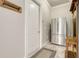 Hallway with stainless steel refrigerator and 'Beware of Weiner' dachshund sign at 3979 Mammoth Grove Rd, Lake Wales, FL 33898