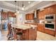 Beautiful kitchen featuring wood cabinets, granite countertops, a tile backsplash, and a large center island at 3979 Mammoth Grove Rd, Lake Wales, FL 33898
