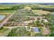 Aerial view of a vacant lot outlined in red with lush greenery and scattered trees, ready for new construction at 3979 Mammoth Grove Rd, Lake Wales, FL 33898