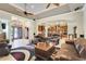 Spacious living room featuring leather furniture, a ceiling fan, and open access to the kitchen at 3979 Mammoth Grove Rd, Lake Wales, FL 33898