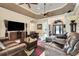Elegant living room featuring leather furniture and modern entertainment center at 3979 Mammoth Grove Rd, Lake Wales, FL 33898
