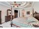 Bright bedroom with a four-poster bed, detailed ceiling, and classic decor at 3979 Mammoth Grove Rd, Lake Wales, FL 33898