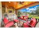 Screened-in patio includes full outdoor kitchen, tv, ceiling fans and seating area overlooking the lush backyard at 3979 Mammoth Grove Rd, Lake Wales, FL 33898