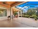 Spacious screened patio offering outdoor living and entertaining space with views of the backyard at 3979 Mammoth Grove Rd, Lake Wales, FL 33898
