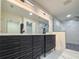 Modern bathroom boasts a double vanity and glass-enclosed shower at 481 S East Ave, Bartow, FL 33830