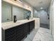 Modern bathroom boasts a double vanity and glass-enclosed shower at 481 S East Ave, Bartow, FL 33830