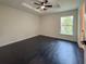 Spacious bedroom features a ceiling fan and dark wood floors at 481 S East Ave, Bartow, FL 33830