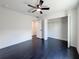 This bedroom features dark floors, a ceiling fan, and a closet at 481 S East Ave, Bartow, FL 33830