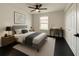 Cozy bedroom with neutral carpet, bed, side tables, desk, chair and ceiling fan at 481 S East Ave, Bartow, FL 33830