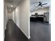 Hallway view leads to kitchen with a modern island, black backsplash and stainless steel refrigerator at 481 S East Ave, Bartow, FL 33830