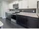 Close-up of kitchen with marble countertops, stainless steel appliances, and elegant black subway tile backsplash at 481 S East Ave, Bartow, FL 33830
