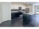 Stylish kitchen with black island, stainless steel appliances, and white and black cabinets for a modern touch at 481 S East Ave, Bartow, FL 33830
