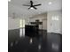 Modern kitchen features a large island, sleek appliances, and elegant black hardwood flooring at 481 S East Ave, Bartow, FL 33830