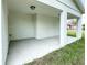 Covered patio with concrete flooring and white columns; perfect for outdoor relaxation at 481 S East Ave, Bartow, FL 33830