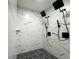 Sleek glass shower features rainfall showerheads and pebble flooring at 481 S East Ave, Bartow, FL 33830
