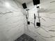 Sleek glass shower features rainfall showerheads and pebble flooring at 481 S East Ave, Bartow, FL 33830