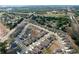 Aerial view of a residential neighborhood with well-manicured lawns, sidewalks, and a community pool at 8830 Fox Dr, Polk City, FL 33868
