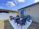 Inviting backyard patio featuring wicker furniture and a grill, perfect for outdoor entertaining at 8830 Fox Dr, Polk City, FL 33868