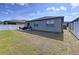 Large backyard with a well-maintained lawn, patio, and white fencing for privacy at 8830 Fox Dr, Polk City, FL 33868