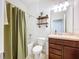 Well-lit bathroom featuring a shower-tub combo, decor shelving, and tiled floors at 8830 Fox Dr, Polk City, FL 33868