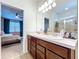 Bathroom featuring a double sink vanity and an ensuite bedroom with a ceiling fan at 8830 Fox Dr, Polk City, FL 33868