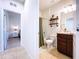 Well-lit bathroom featuring a shower-tub combo with wood-look shelves and tiled floors at 8830 Fox Dr, Polk City, FL 33868