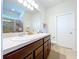 Bathroom with a double sink vanity, a tiled floor, and an enclosed shower at 8830 Fox Dr, Polk City, FL 33868