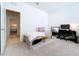 Cozy bedroom with carpeted floors featuring a twin bed, a work desk, and ample natural light at 8830 Fox Dr, Polk City, FL 33868