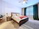 Cozy bedroom with soft carpet, large window, and neutral décor at 8830 Fox Dr, Polk City, FL 33868