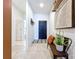 Inviting entryway with tiled floor, bench and decorative art at 8830 Fox Dr, Polk City, FL 33868
