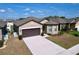 Charming single-story home boasting a well-maintained lawn, two-car garage, and inviting curb appeal at 8830 Fox Dr, Polk City, FL 33868